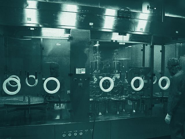 Operators at an aseptic fill line in a cleanroom
